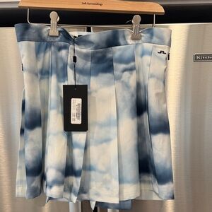 J.Lindeberg Adina Printed Golf Skirt in a blue and white cloud pattern. L